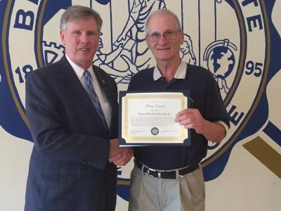 Retired Bluefield State College educator Roger Owensby (right) was awarded 'Faculty Emeritus' designation during BSC's 2019 Employee Recognition & Retiree Celebration program. He is pictured with Bluefield State College President Robin Capehart.