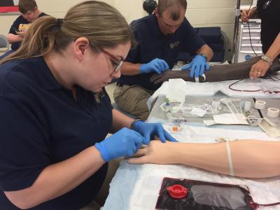 Bluefield State College nursing students Amanda Kuhn (foreground) and Thomas Gillian are preparing intravenous training arms for IV insertion during a recent nursing lab exercise at Bluefield State College.