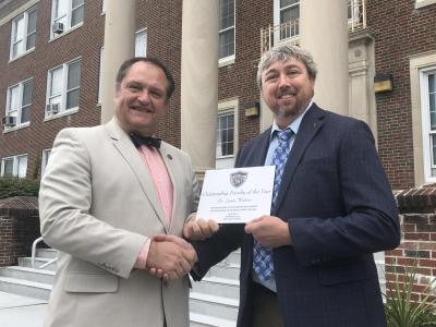 Dr. James Walters (right), Bluefield State College's "Outstanding Faculty of the Year" award recipient for 2018-2019, is congratulated by Dr. Ted Lewis, BSC Provost.