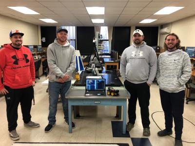 Bluefield State College students (left-to-right) Mason Van Dyke, Caige Clark, David Cavins, and Hunter Hill pose with a microprocessor smart robot-vehicle they created during the fall semester’s ELET-Microprocessors course at BSC.