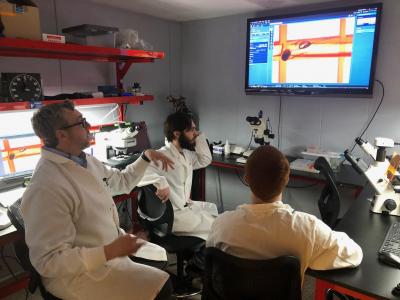 Bluefield State College faculty member Dr. James Walters (left) and two BSC students observed enhanced microscope images in the new Southern WV Imaging Core Facility at the College.