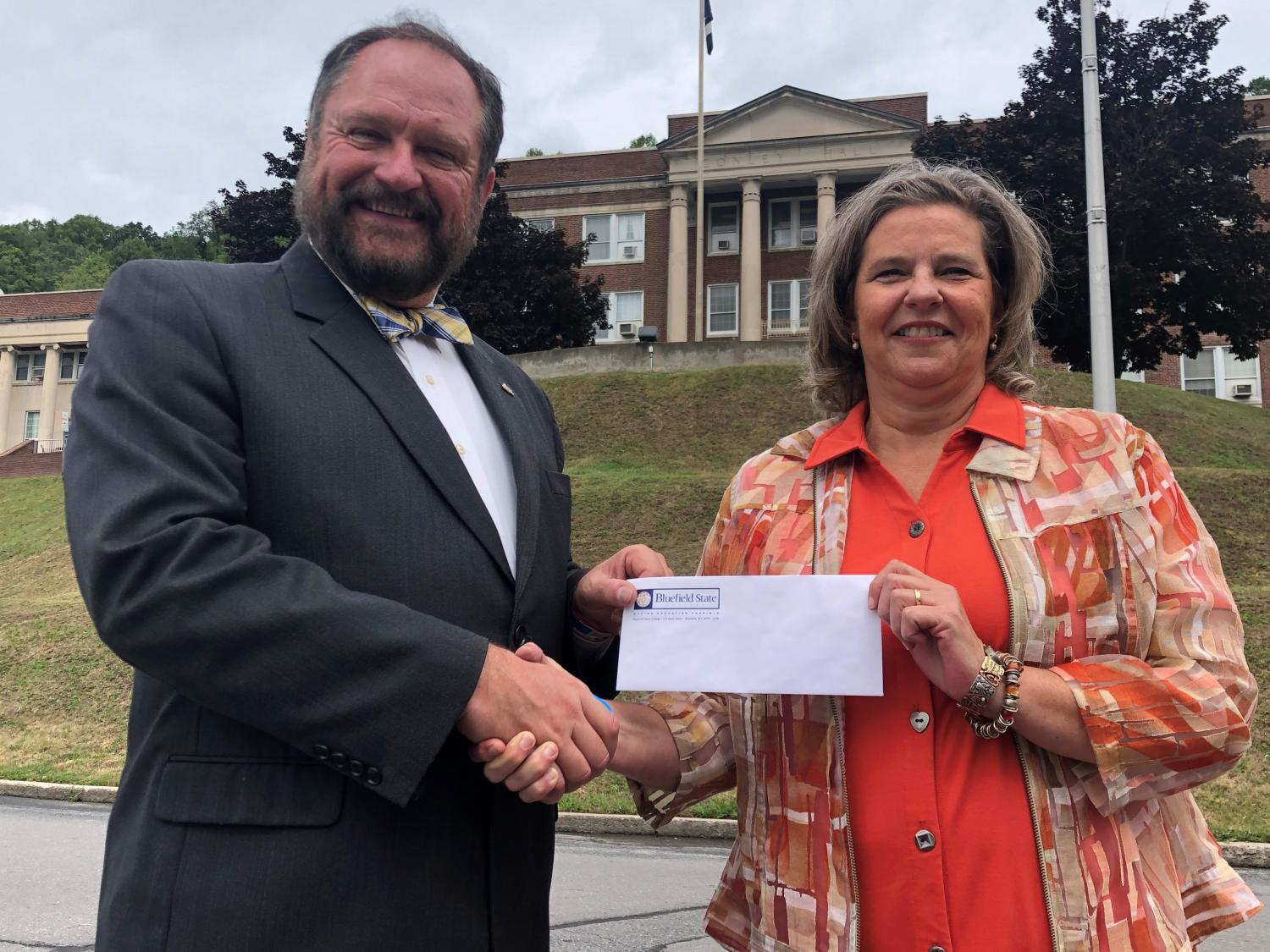 Bluefield State College’s Sherri Williams (right), has been named BSC’s 2020-2021 “Faculty of the Year” Recipient.  Professor Williams is pictured with Dr. Ted Lewis (left), BSC Provost, who presented her with a $1000 check from the Bluefield State College Foundation in recognition of her selection for the award.