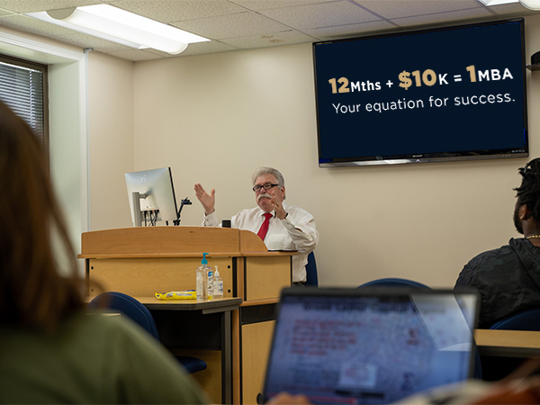 Dr. Jerry Wood, Director of the Bluefield State University Business Administration Program at the W. Paul Cole, Jr. School of Business, discusses course content with MBA students in the program.