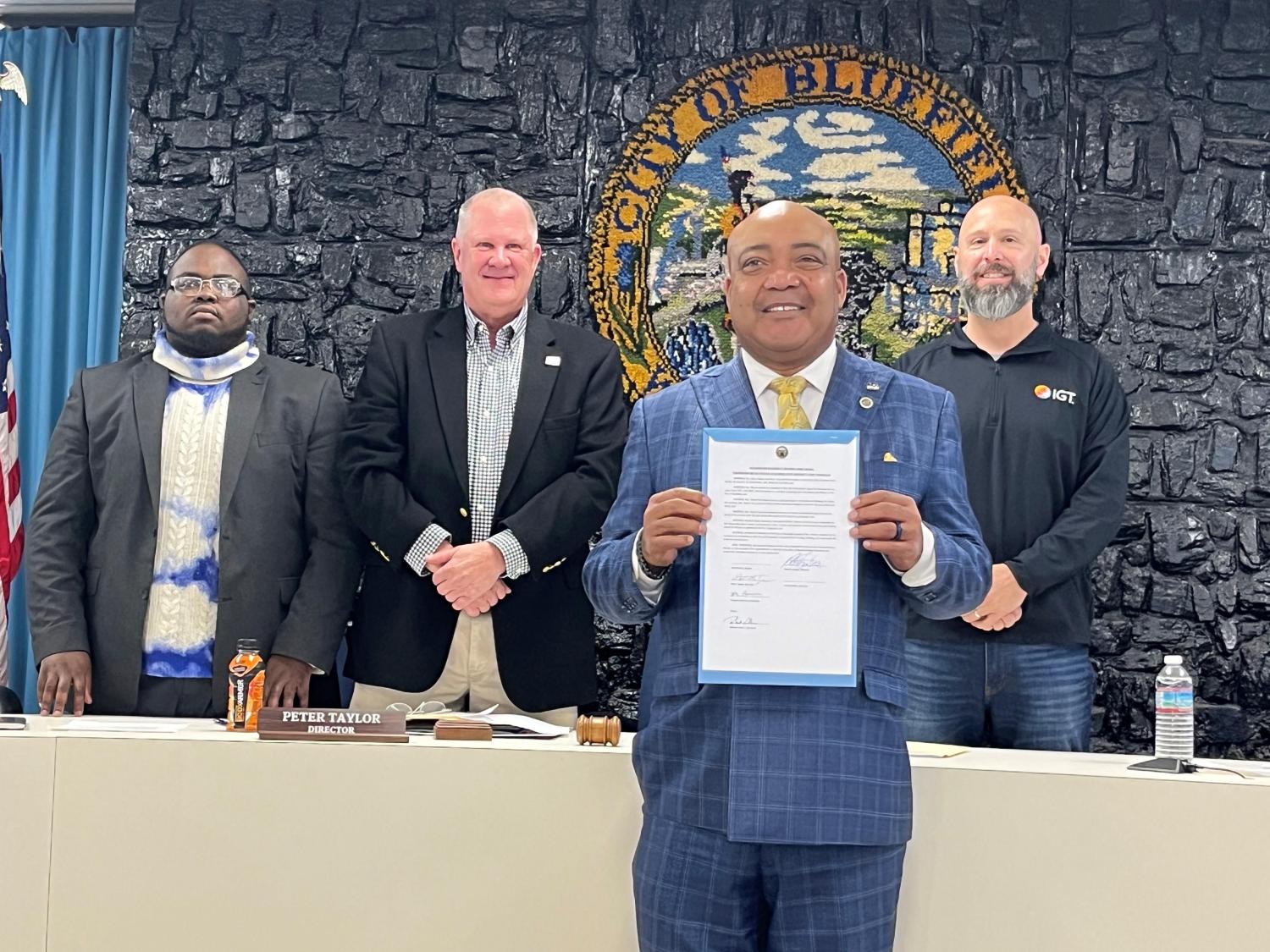 The Reverend Garry Moore (foreground) was honored by the Bluefield City Board of Directors at its November 22 meeting.  Moore, the first Chancellor in Bluefield State University’s history, received a resolution citing his service to church, community, and BSU.  Pictured (second row, left-to-right) are Board members Treyvon Simmons, Peter Taylor, and Matt Knowles.